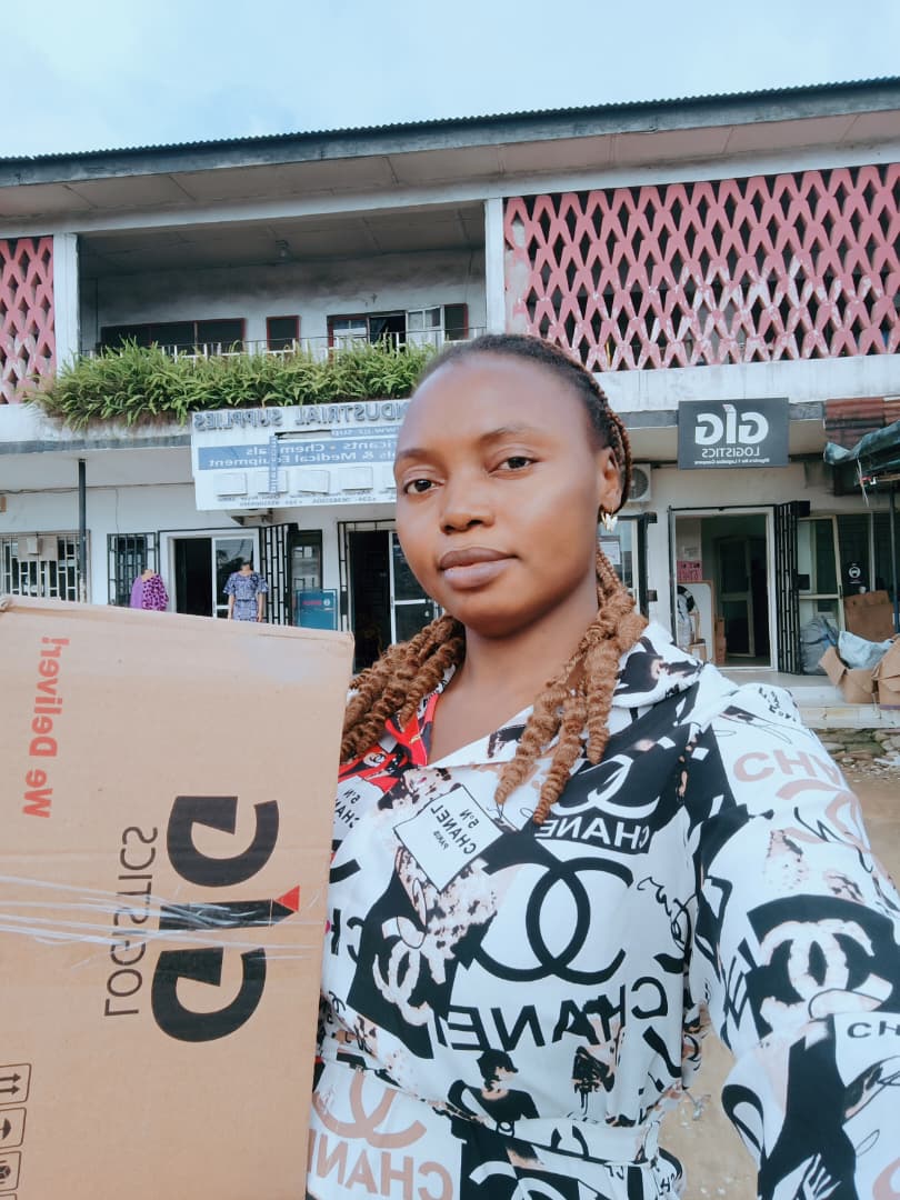 Happiness, Bauchi State Coordinator, collecting a shipped laptop at the logistics office.