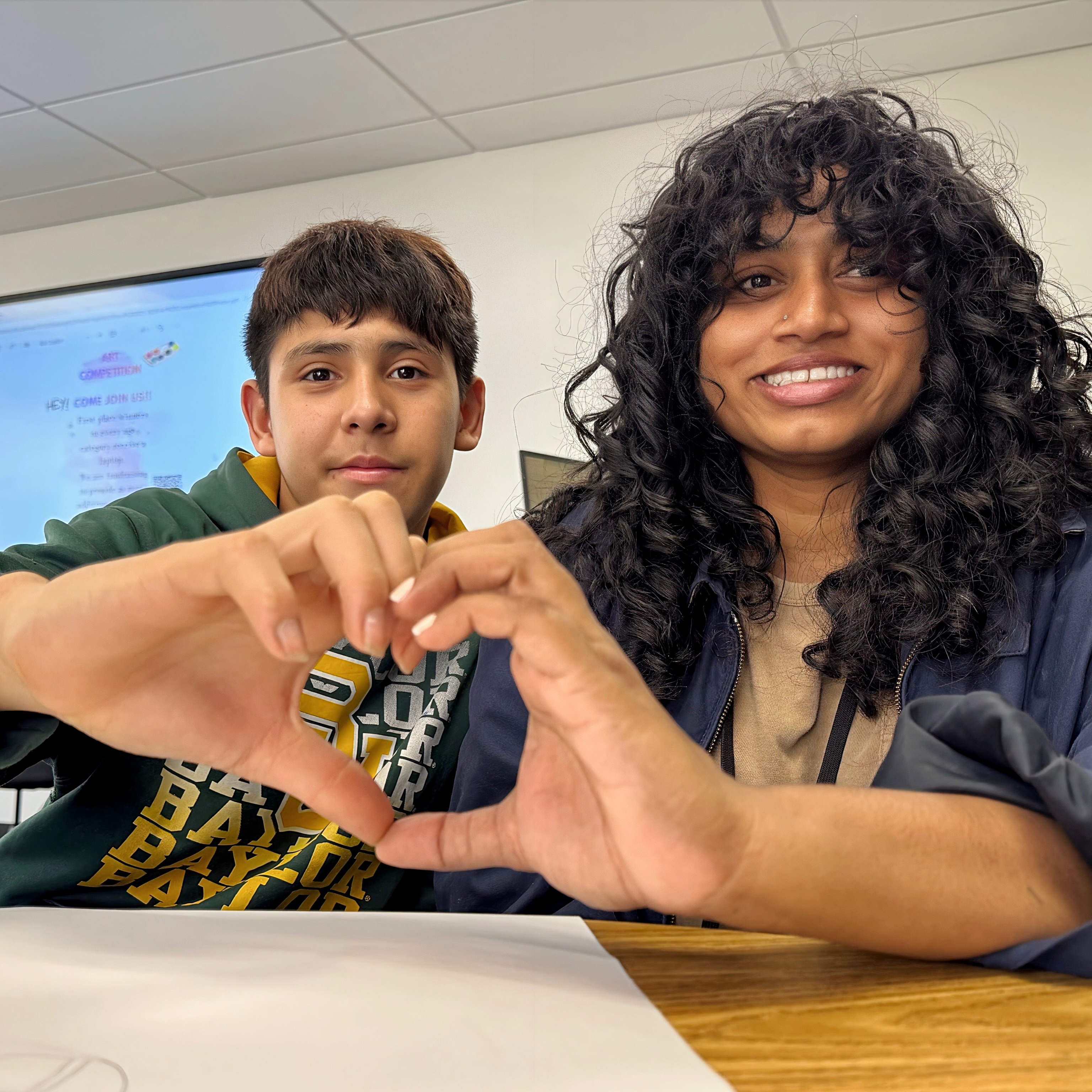 Clear Lake High School Special Education teacher and student forming a heart with their hands