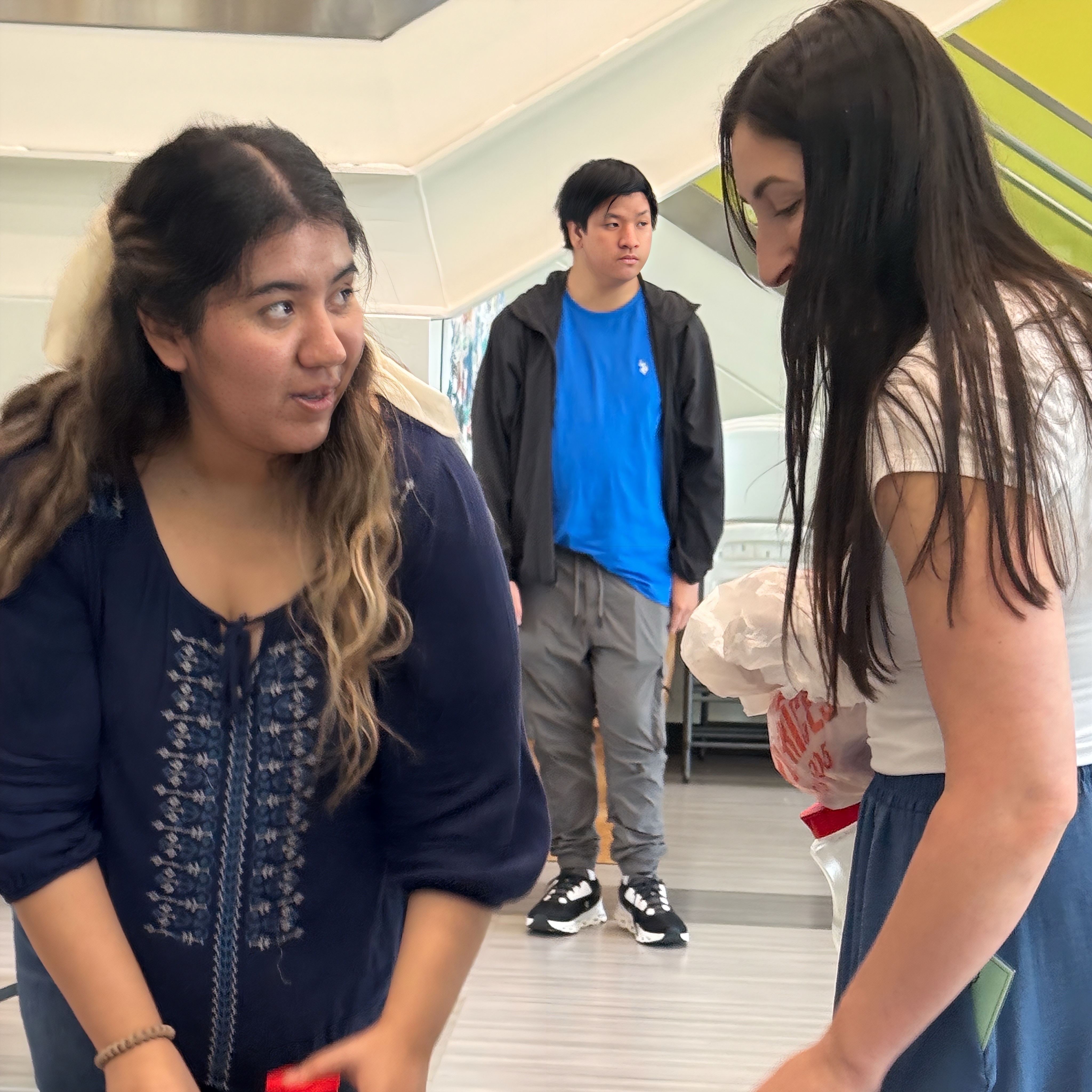 Diana Mendoza, Alex Nguyen, and Annie Jones behind the scenes